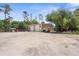 Exterior view of a spacious garage and ample parking area, offering plenty of room for vehicles and equipment at 3950 Pepper Ln, North Port, FL 34287