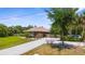 Charming one-story home with a tile roof, lush landscaping, and long driveway providing ample parking at 3950 Pepper Ln, North Port, FL 34287