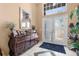 Welcoming foyer features elegant tile flooring, decorative mirror, and a classic wooden console table at 3950 Pepper Ln, North Port, FL 34287