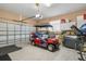 Attached garage features a garage door, storage space, and golf cart at 3950 Pepper Ln, North Port, FL 34287