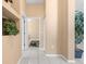 Neutral hallway leads to rooms with tile flooring at 3950 Pepper Ln, North Port, FL 34287
