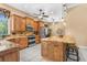 Well-lit kitchen with stainless appliances, granite counters, and wooden cabinets for ample storage at 3950 Pepper Ln, North Port, FL 34287