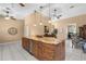 Open kitchen boasts a granite-topped island with seating, ideal for entertaining and dining at 3950 Pepper Ln, North Port, FL 34287