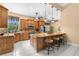 Spacious kitchen features custom cabinets, granite countertops, and an island with seating at 3950 Pepper Ln, North Port, FL 34287