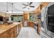 Bright, open kitchen with stainless steel appliances, granite countertops, and a large center island at 3950 Pepper Ln, North Port, FL 34287
