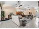 Spacious living room featuring tile floors, stylish furniture, and an open layout flowing into the dining area at 3950 Pepper Ln, North Port, FL 34287