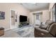 Bright living room with neutral walls, tile flooring, large-screen TV, and comfortable seating at 3950 Pepper Ln, North Port, FL 34287