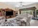 Open living space features tile floors, plush seating, entertainment center, and access to the outdoors at 3950 Pepper Ln, North Port, FL 34287
