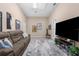 Spacious living room with a large-screen TV, comfortable sofa, and movie posters for entertainment at 3950 Pepper Ln, North Port, FL 34287