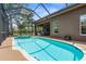 Screened-in pool area with a spacious pool and spa, ideal for outdoor enjoyment and relaxation at 3950 Pepper Ln, North Port, FL 34287