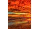 A breathtaking sunset at the beach with vibrant orange and gold hues at 3950 Pepper Ln, North Port, FL 34287