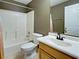 Well-lit bathroom with a tiled shower/tub combo and wood vanity at 4103 Kinlock St, North Port, FL 34286
