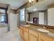 Bathroom features double sinks, a large mirror, shower, and a soaking tub for relaxation at 4103 Kinlock St, North Port, FL 34286