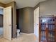 Neutral bathroom with a toilet, wooden cabinet, and tiled floor provides a peaceful space at 4103 Kinlock St, North Port, FL 34286