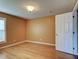 Bright bedroom featuring hardwood floors, warm paint, and a door to the hall at 4103 Kinlock St, North Port, FL 34286