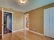 This bedroom offers wood floors, neutral paint, and two doorways, one with a view to a bathroom at 4103 Kinlock St, North Port, FL 34286