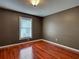 Cozy bedroom with wood floors, neutral walls, and a window with blinds at 4103 Kinlock St, North Port, FL 34286