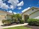 Inviting entrance with green front door, beautiful landscaping, and a paved walkway under a sunny sky at 4103 Kinlock St, North Port, FL 34286