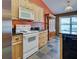 Kitchen with wood cabinets, black countertops, modern appliances, and tile flooring at 4103 Kinlock St, North Port, FL 34286