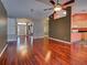 Spacious living room with hardwood floors, a decorative ceiling fan, and ample space for entertaining or relaxing at 4103 Kinlock St, North Port, FL 34286