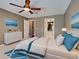 Comfortable main bedroom featuring a ceiling fan, ensuite bathroom, and a calm color palette at 4103 Kinlock St, North Port, FL 34286