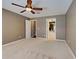View of the main bedroom with neutral walls, ceiling fan, and doorways to other rooms at 4103 Kinlock St, North Port, FL 34286