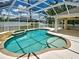 Inviting pool area with screened enclosure, spa, and ample deck space for outdoor enjoyment at 4103 Kinlock St, North Port, FL 34286