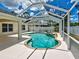 This backyard pool has a full screen enclosure and integrated hot tub to enjoy in a peaceful setting at 4103 Kinlock St, North Port, FL 34286