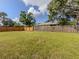 Large backyard with a wooden fence and plenty of green space at 4192 Tarpon Rd, Venice, FL 34293
