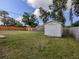 Spacious backyard featuring a white storage shed and wooden fence at 4192 Tarpon Rd, Venice, FL 34293