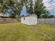 Backyard featuring a white storage shed with a wooden fence backdrop at 4192 Tarpon Rd, Venice, FL 34293
