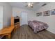 A cozy bedroom with wood-look floors, a TV, and a comfortable bed at 4192 Tarpon Rd, Venice, FL 34293