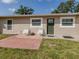 The home's front exterior features a small patio with chairs, complemented by a lush green lawn at 4192 Tarpon Rd, Venice, FL 34293