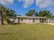 A well-kept front yard, mature trees, and a carport enhance this charming single-story home at 4192 Tarpon Rd, Venice, FL 34293