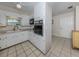 An efficient kitchen featuring white cabinets, built-in appliances, and access to the hallway at 4192 Tarpon Rd, Venice, FL 34293