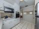An efficient kitchen space with built-in appliances, white cabinets, and natural light at 4192 Tarpon Rd, Venice, FL 34293