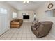 Bright living room with tile flooring, ceiling fan, and comfortable seating arrangement at 4192 Tarpon Rd, Venice, FL 34293