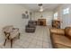 Bright living room with a ceiling fan, tile flooring, and a functional desk area at 4192 Tarpon Rd, Venice, FL 34293