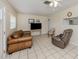 The living room features neutral paint and tile floors, complemented by cozy seating options at 4192 Tarpon Rd, Venice, FL 34293