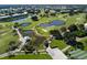 Scenic aerial view of the lush golf course, water features, and residences at 421 Cerromar Ter # 471, Venice, FL 34293