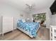 Light-filled bedroom featuring a ceiling fan and access to a private balcony at 421 Cerromar Ter # 471, Venice, FL 34293