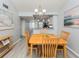 Inviting dining area featuring a wooden table, pendant lights, and access to the kitchen at 421 Cerromar Ter # 471, Venice, FL 34293