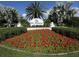 Welcoming community entrance with lush flower beds, palm trees, and clear signage to greet residents and visitors at 421 Cerromar Ter # 471, Venice, FL 34293