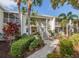 Inviting condo exterior featuring lush landscaping and screened balconies, a tropical oasis at 421 Cerromar Ter # 471, Venice, FL 34293