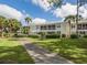 Condominiums featuring screened patios and balconies, enhanced by verdant landscaping and a paved walking path at 421 Cerromar Ter # 471, Venice, FL 34293