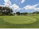 Picturesque golf course with a serene pond backdrop, perfect for a relaxing game and enjoying nature's beauty at 421 Cerromar Ter # 471, Venice, FL 34293