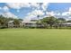 A view of a golf course and ponds with condos, enhanced by a verdant landscape at 421 Cerromar Ter # 471, Venice, FL 34293