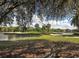 Picturesque view of the golf course with water features, beautiful sky, and mature trees at 421 Cerromar Ter # 471, Venice, FL 34293