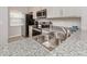 Well-lit kitchen featuring stainless steel appliances, granite countertops and neutral color palette at 421 Cerromar Ter # 471, Venice, FL 34293