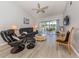 Cozy living room with a ceiling fan and screened patio doors offering a view outside at 421 Cerromar Ter # 471, Venice, FL 34293